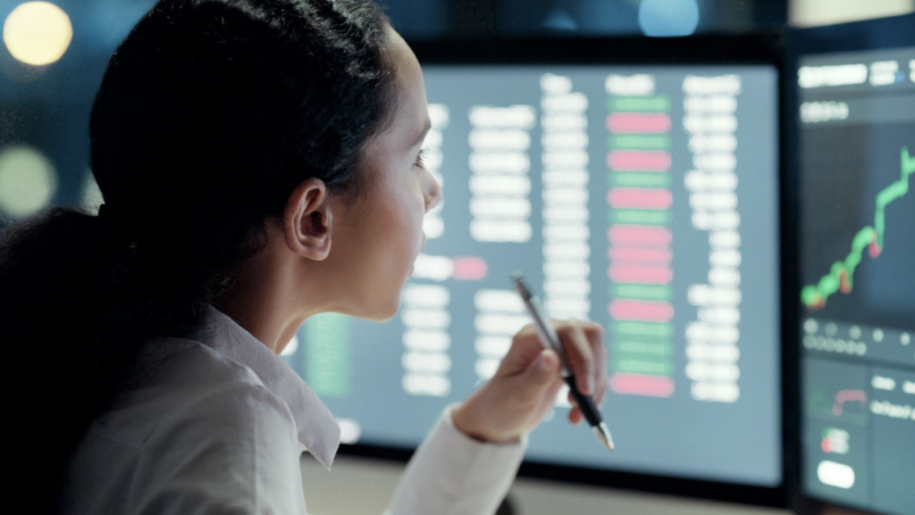 A business owner reviews data at her computer of details from her earnify fleet rewards program.