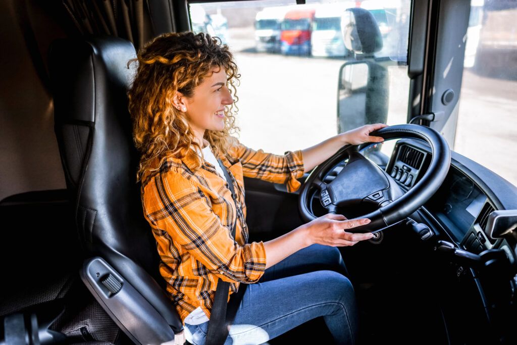 A fleet driver sits in her truck preparing to start her route.