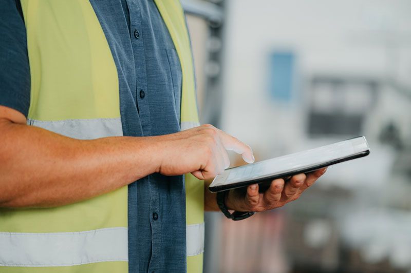 A fleet manager reviews fleet card data of his drivers in real-time on his tablet.