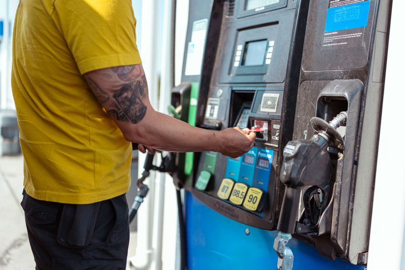 A fleet driver pays for fuel at the pump with a fleet card.