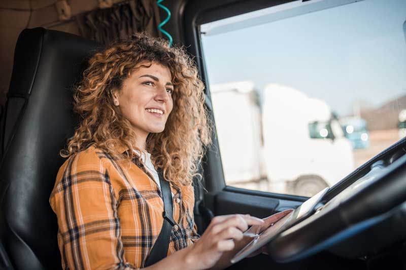 A fleet driver using fuel card app on her tablet.