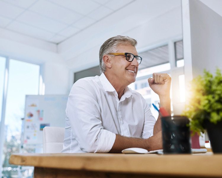 A fleet business owner reviews fleet card data in real-time on his office computer.